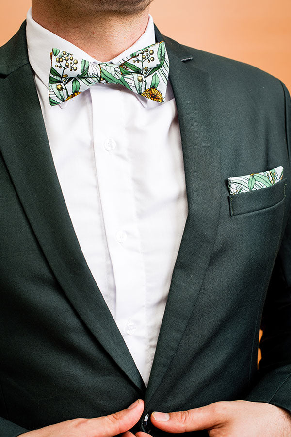 Stylish bow tie in grey adorned with a vibrant Banksia floral motif, ideal for nature-inspired fashion and special occasions
