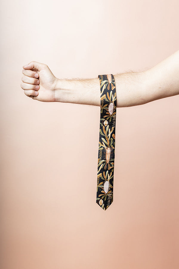 Elegant black cotton tie featuring a subtle Grass Tree pattern, inspired by the resilience of Australian bush flora