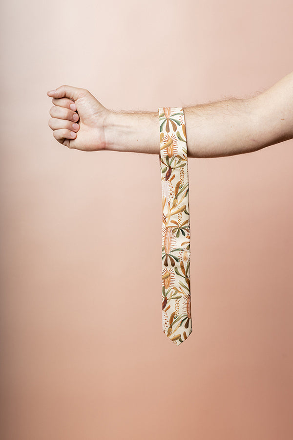 100% cotton tie showcasing a detailed Grass Tree motif in warm earthy hues, reflecting the beauty and toughness of Australian flora