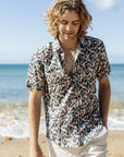 Relaxed fit short sleeve shirt adorned with delicate pink Flowering Gum blossoms and dark green leaves