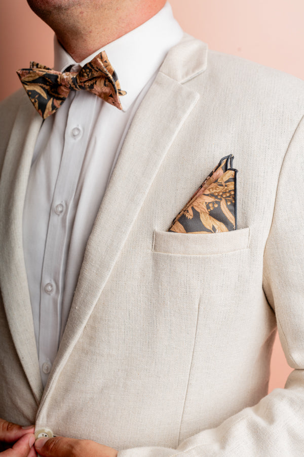 Elegant 100% cotton pocket square adorned with a variety of Australian native flora in shades of neutrals, peaches, and pinks, perfect for adding a distinctive touch to formal attire