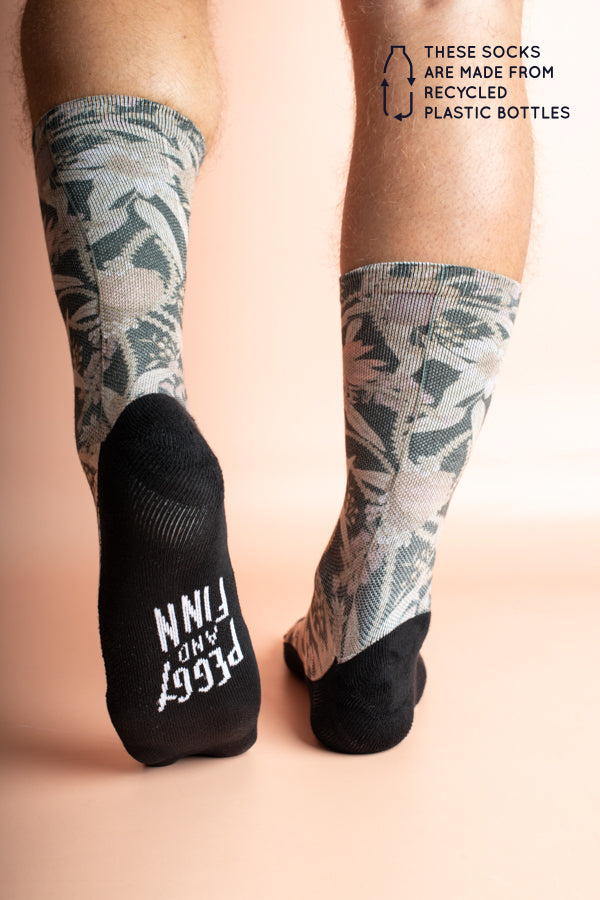 Charcoal grey socks decorated with colorful Australian flora including Banksia and Gum Leaves, crafted from recycled plastic bottles