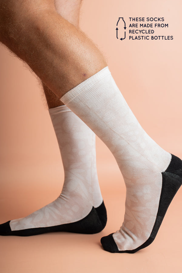 Sustainable socks made from recycled materials, adorned with minimalist floral patterns in sand and white for a subtle, stylish look