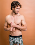 Eco-friendly boxer briefs featuring stylish Protea patterns on a green background