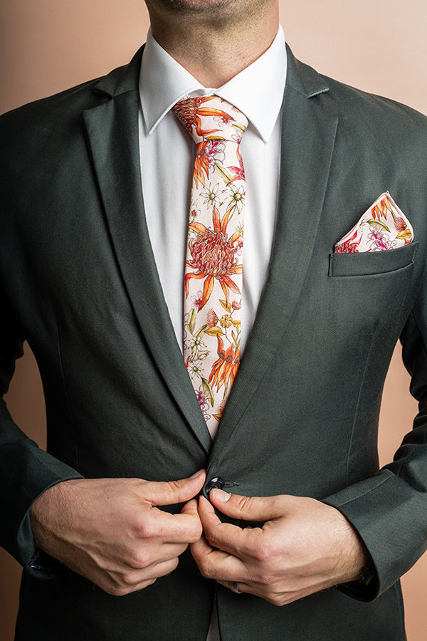 100% cotton tie showcasing an array of colorful native flowers, blending nature-inspired beauty with fashionable design