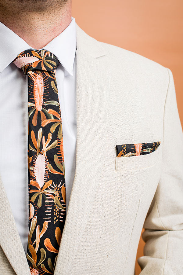Artistic pocket square showcasing grass trees thriving in nutrient-poor soils, rendered in colors of black, burnt orange, and green, ideal for enhancing any suit with a botanical flair