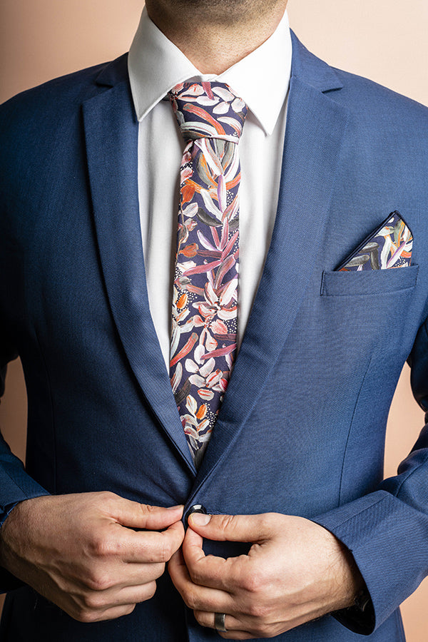 Navy cotton tie featuring an intricate protea floral print, showcasing the detailed petals and foliage of this stunning flower