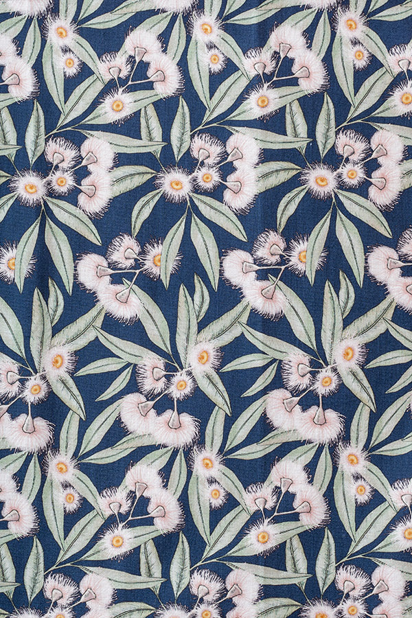 Vibrant print featuring pale pink flowering gum blossoms set against a steel blue background, capturing the essence of Australian summer blooms