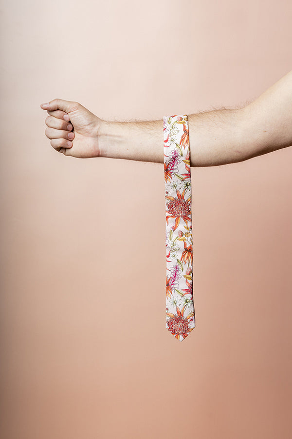Stylish botanical tie crafted from cotton, featuring vivid prints of red Waratah, pink Desert Pea, and orange Wax Flowers, perfect for special occasions