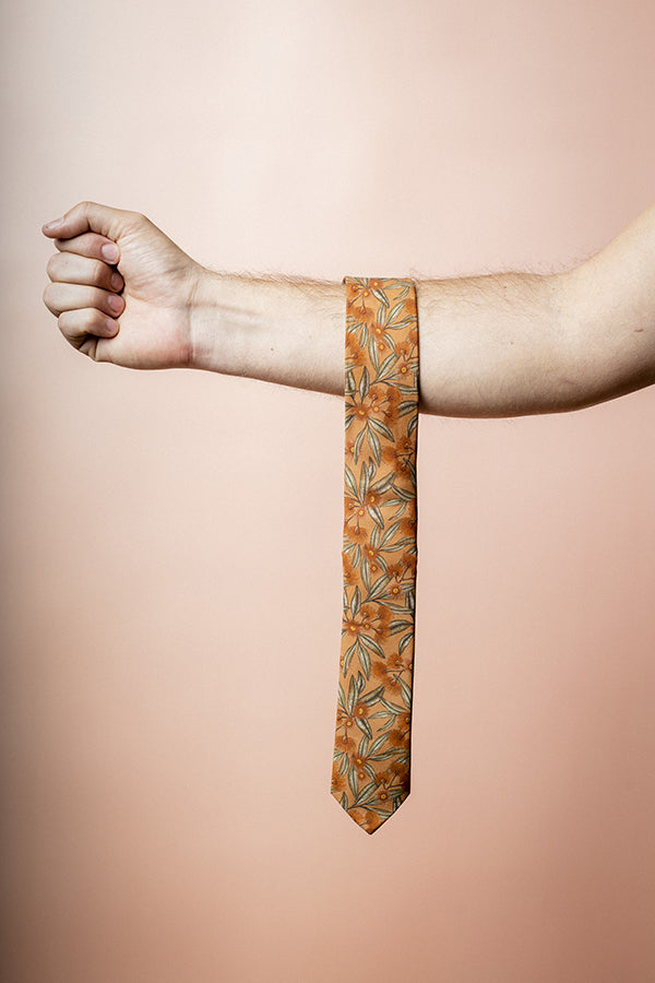 Stylish terracotta tie crafted from cotton, featuring flowering gum designs in shades of pink and green, perfect for formal and casual settings