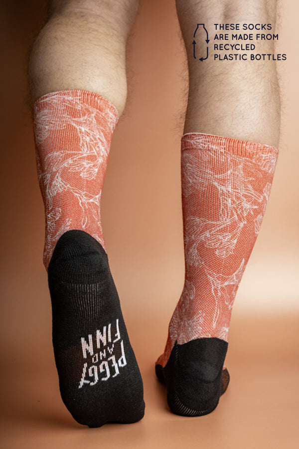 Eco-friendly socks featuring a Kangaroo Paw print in burnt orange, inspired by the unique flora of Australia